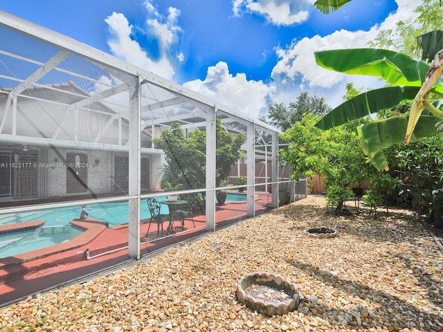 view of pool featuring glass enclosure