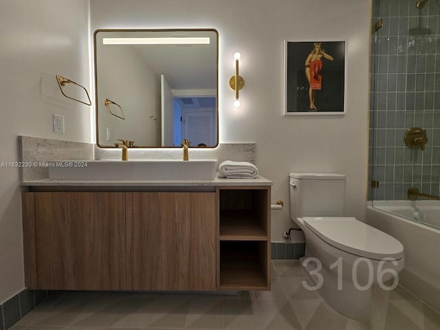 full bathroom featuring vanity, toilet, tiled shower / bath, and tile patterned flooring