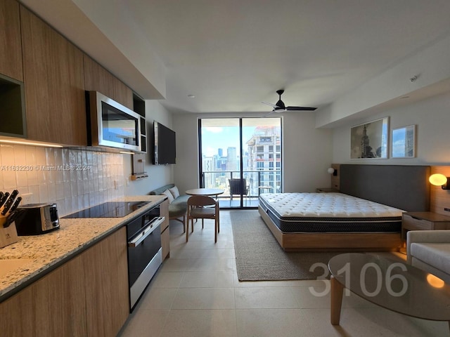 tiled bedroom featuring ceiling fan