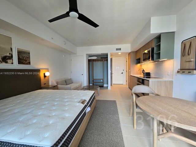 bedroom featuring a closet, ceiling fan, and light tile patterned floors