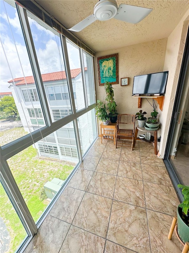 sunroom / solarium with a wealth of natural light and ceiling fan