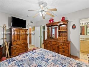 bedroom featuring ensuite bath and ceiling fan