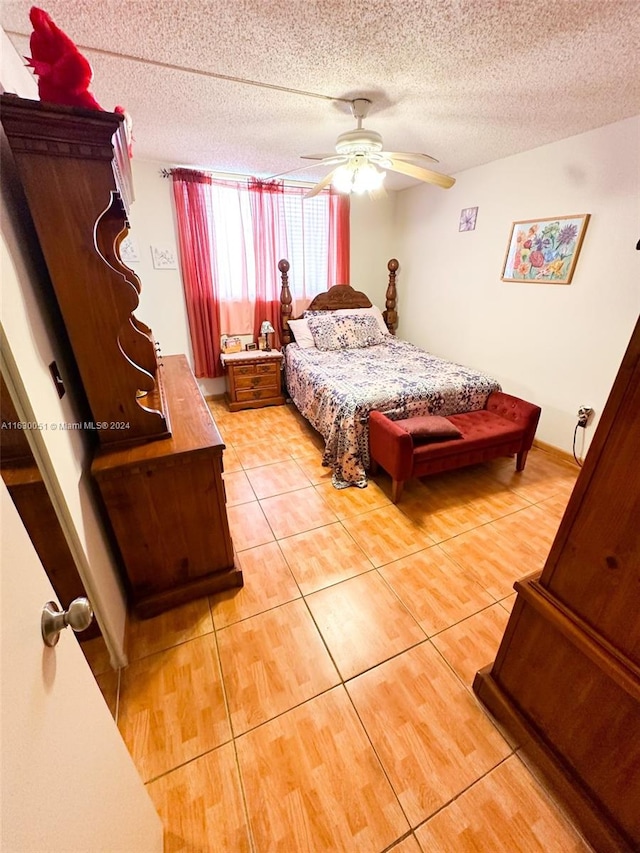 tiled bedroom with a textured ceiling and ceiling fan