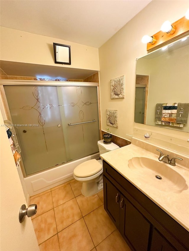 full bathroom with vanity, toilet, tile patterned flooring, and enclosed tub / shower combo