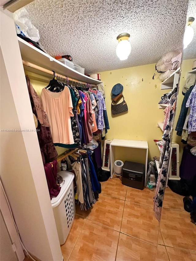 spacious closet with light tile patterned floors