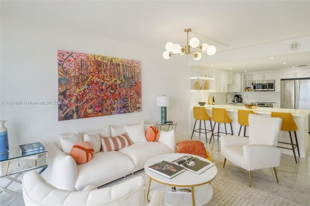 living room with sink, light tile patterned flooring, and a chandelier