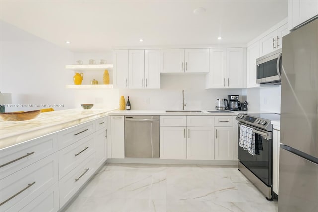 kitchen featuring a sink, white cabinets, marble finish floor, appliances with stainless steel finishes, and open shelves