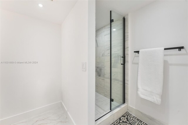 bathroom featuring tile patterned flooring and an enclosed shower