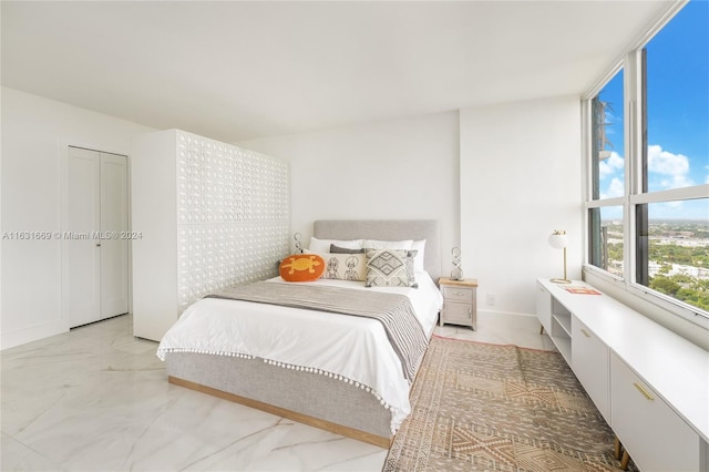 bedroom featuring marble finish floor and baseboards