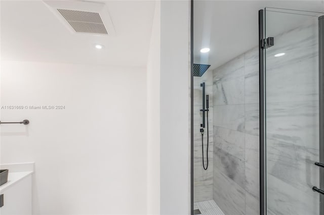 full bathroom featuring recessed lighting, visible vents, and a marble finish shower