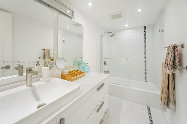 bathroom featuring tile patterned floors, vanity, and tiled shower / bath combo