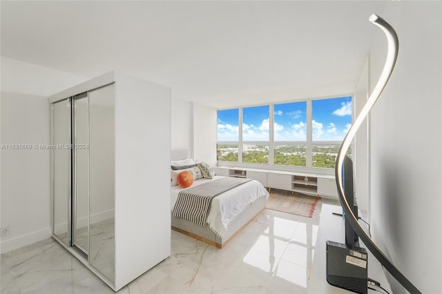 tiled bedroom with a closet and refrigerator