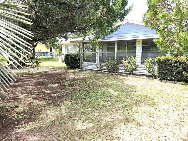 view of yard with a sunroom