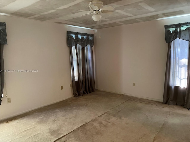 unfurnished room with ceiling fan and light colored carpet