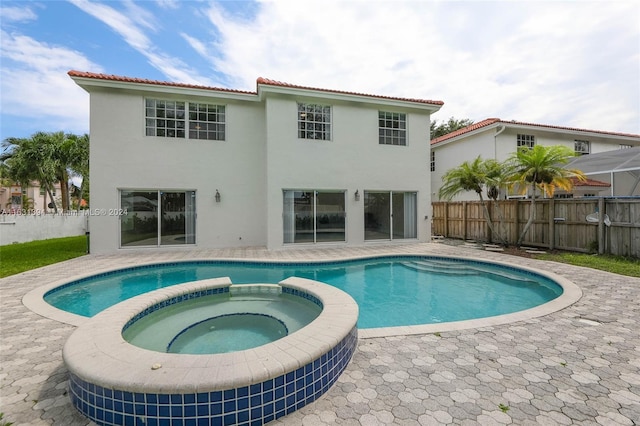 13377 NW 7th St, Plantation, FL 33325 - view of pool featuring fence, a patio, and a pool with connected hot tub