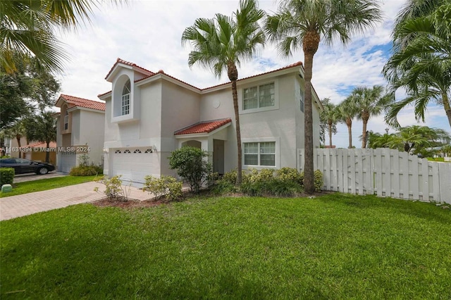 13377 NW 7th St, Plantation, FL 33325 - mediterranean / spanish-style home featuring fence, an attached garage, stucco siding, decorative driveway, and a tiled roof