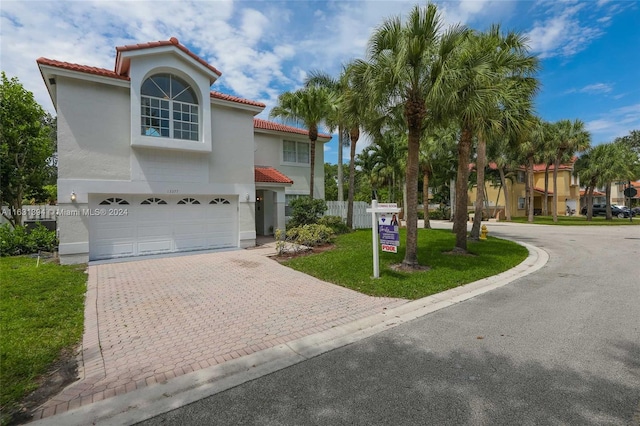 13377 NW 7th St, Plantation, FL 33325 - mediterranean / spanish house with a garage, stucco siding, driveway, and a tile roof
