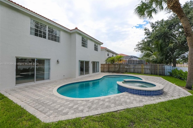 13377 NW 7th St, Plantation, FL 33325 - view of swimming pool featuring a patio, fence, and a pool with connected hot tub