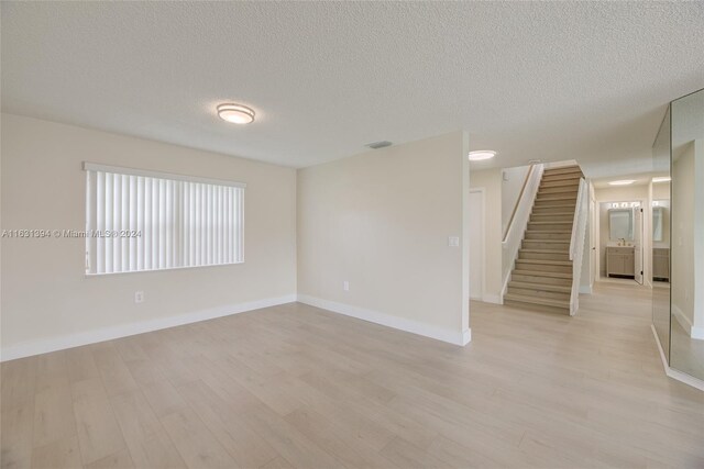 13377 NW 7th St, Plantation, FL 33325 - empty room with baseboards, light wood finished floors, and stairs