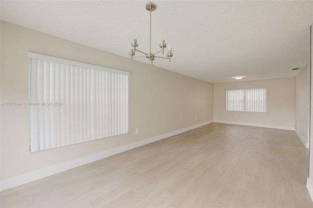 13377 NW 7th St, Plantation, FL 33325 - spare room featuring baseboards, a notable chandelier, light wood-style flooring, and visible vents