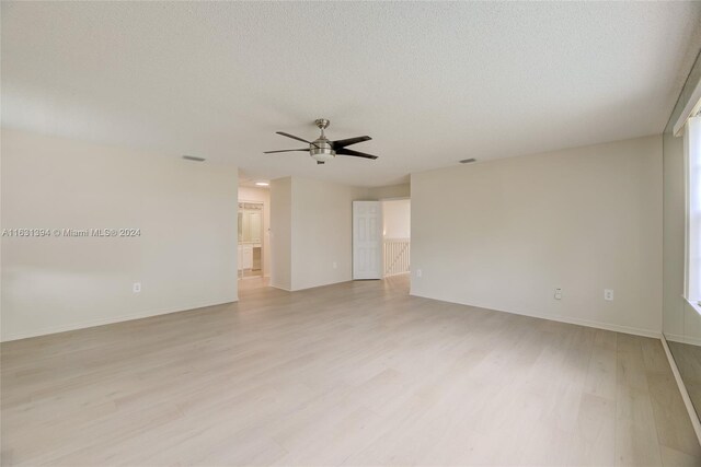 13377 NW 7th St, Plantation, FL 33325 - spare room featuring baseboards, ceiling fan, light wood-type flooring, and a textured ceiling