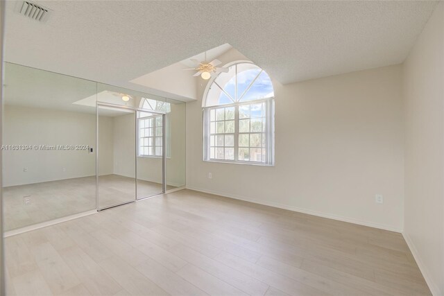 13377 NW 7th St, Plantation, FL 33325 - unfurnished bedroom featuring a ceiling fan, a textured ceiling, visible vents, wood finished floors, and baseboards