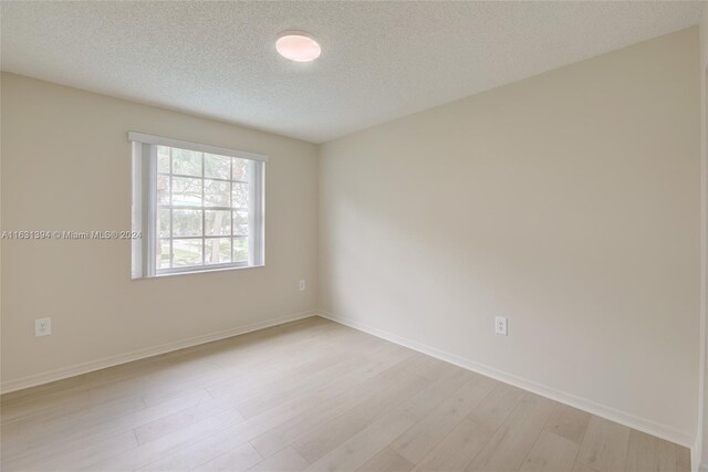 13377 NW 7th St, Plantation, FL 33325 - unfurnished room featuring a textured ceiling, baseboards, and light wood-style floors