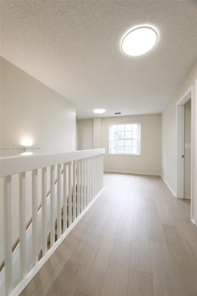 13377 NW 7th St, Plantation, FL 33325 - hall featuring baseboards, a textured ceiling, and wood finished floors