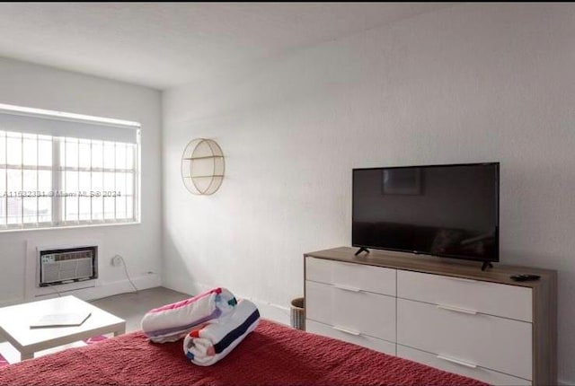 bedroom featuring a wall mounted air conditioner