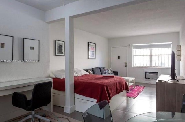 bedroom with an AC wall unit