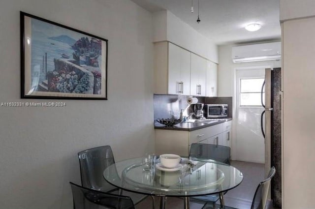 dining area featuring a wall mounted AC