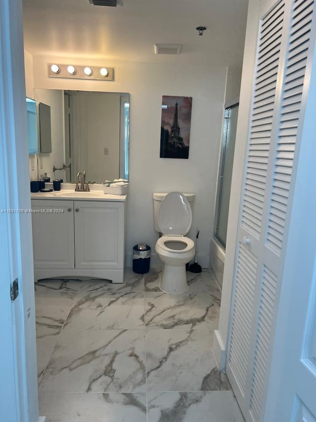 bathroom featuring vanity, toilet, and tile patterned flooring