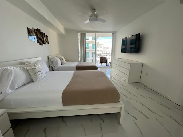 tiled bedroom with expansive windows, ceiling fan, and access to exterior