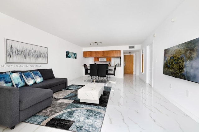 tiled living room featuring rail lighting