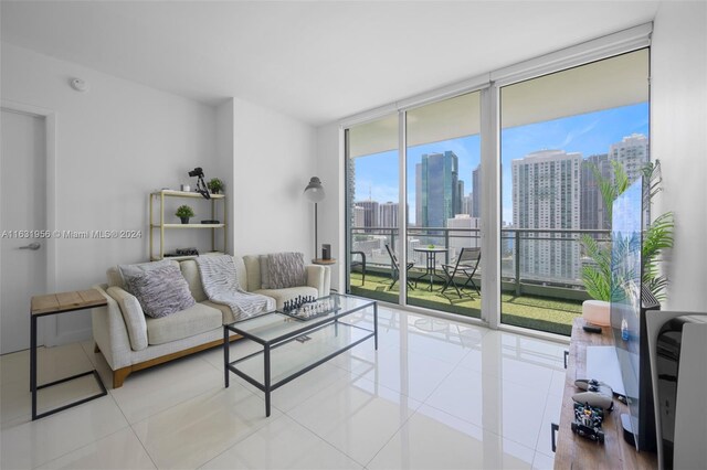 living room with floor to ceiling windows and light tile patterned floors