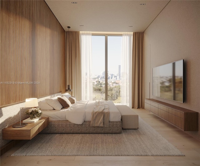 unfurnished bedroom featuring light wood-type flooring and wooden walls