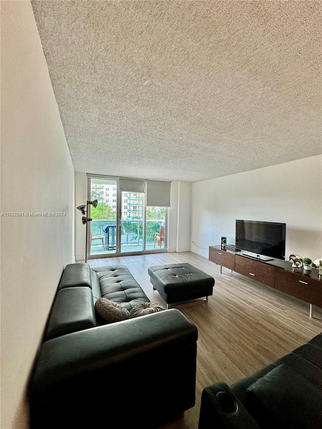 living room featuring a textured ceiling and hardwood / wood-style floors