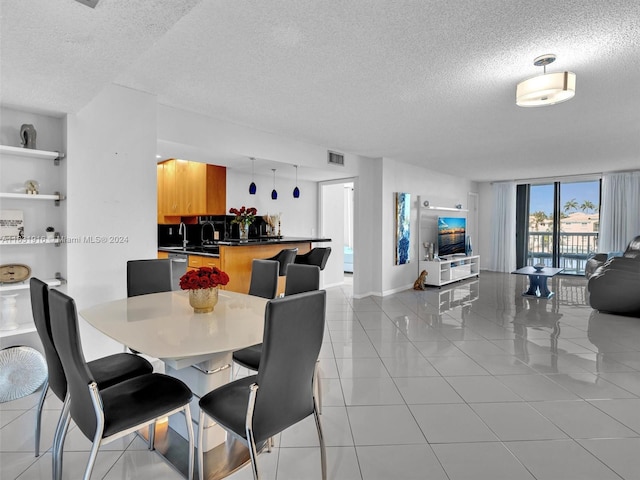 tiled dining room featuring a textured ceiling