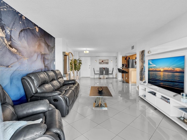 tiled living room featuring a textured ceiling