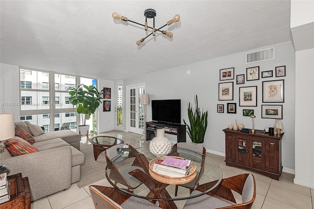 tiled living room featuring expansive windows and french doors