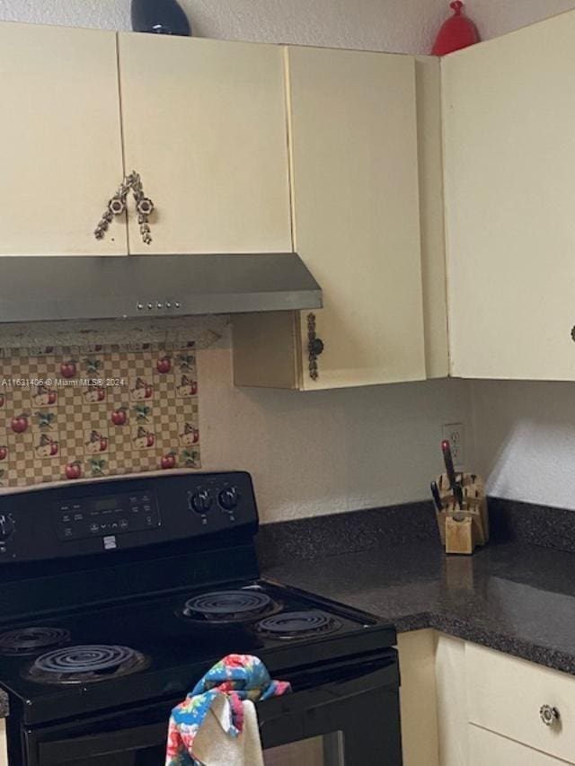 kitchen featuring white cabinetry and black range with electric cooktop