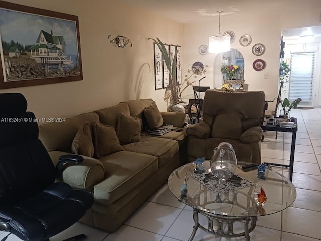 tiled living room featuring a chandelier