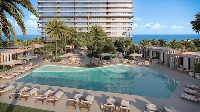 pool featuring a water view and a patio area