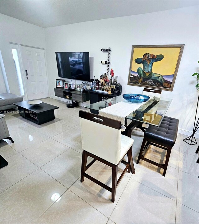 dining area with light tile patterned floors