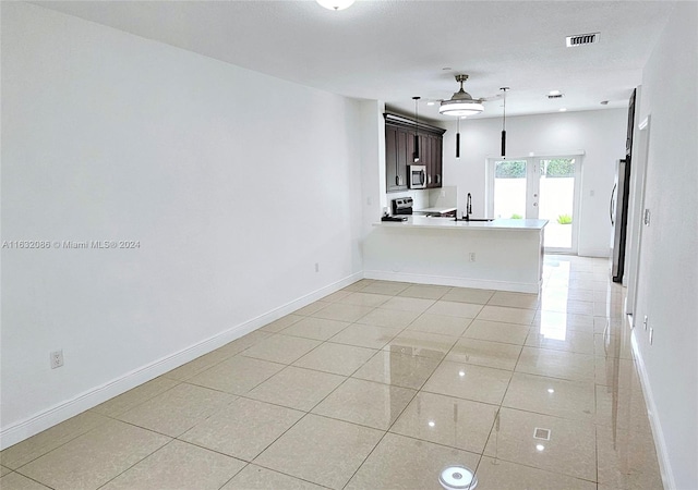 tiled spare room featuring sink