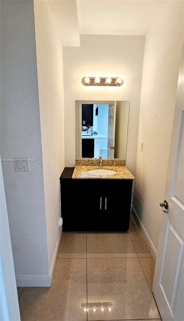 bathroom featuring tile patterned flooring and vanity