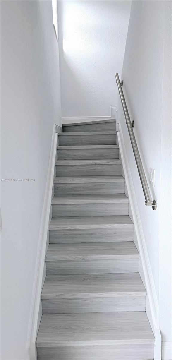 stairway featuring hardwood / wood-style flooring