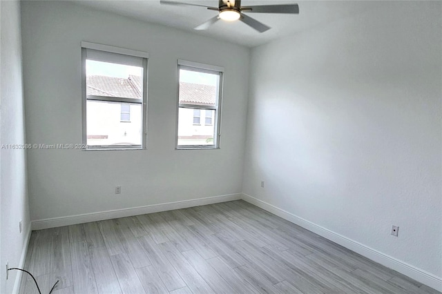 empty room featuring light hardwood / wood-style flooring and ceiling fan