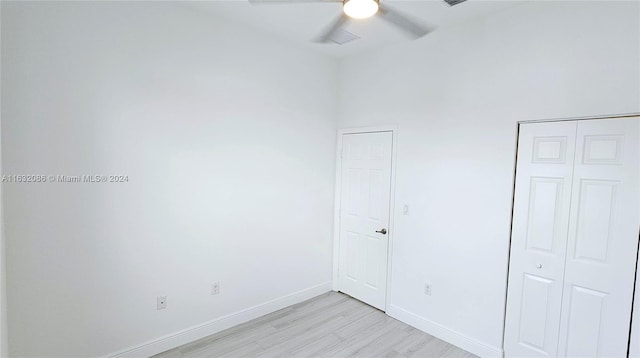 unfurnished bedroom with ceiling fan and light hardwood / wood-style flooring