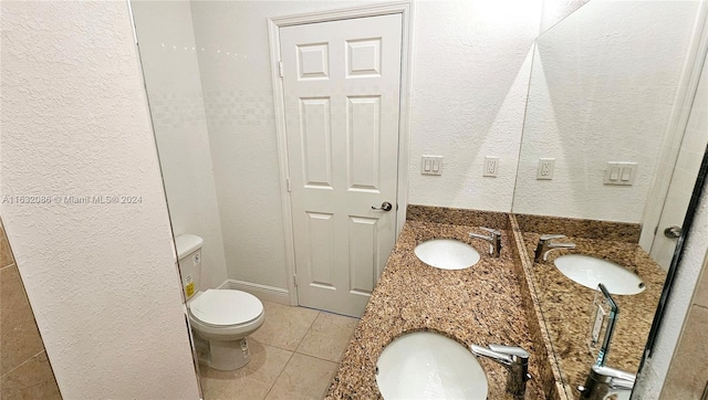 bathroom with vanity, tile patterned flooring, and toilet